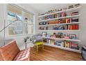 Bright office space with custom shelving, a comfortable chair, and lots of natural light at 414 Wyndham Dr, Chapel Hill, NC 27516