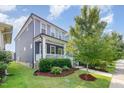 Beautiful home exterior featuring a well-manicured lawn and a charming covered front porch at 442 Granite Mill Blvd, Chapel Hill, NC 27516