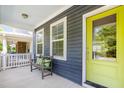Inviting front porch with a cozy bench, vibrant door, and a relaxing outdoor seating area at 442 Granite Mill Blvd, Chapel Hill, NC 27516
