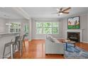 Bright living room features a fireplace, hardwood floors, and views to the backyard at 4804 Carmen Ln, Durham, NC 27707