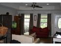 Inviting living room with ample natural light, complemented by neutral walls and a ceiling fan at 503 N Franklin Dr, Sanford, NC 27330