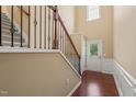 Inviting foyer with hardwood floors, staircase with decorative iron railing, and natural light at 507 Brier Crossings Loop, Durham, NC 27703