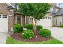 Well-maintained landscaping with green shrubs and mulch bed around the front of the house at 507 Brier Crossings Loop, Durham, NC 27703