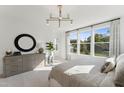 This naturally lit main bedroom includes a dresser and large windows that offer scenic views at 509 Kildaire Farm Rd # 103, Cary, NC 27511