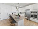 Bright modern kitchen featuring stainless steel appliances, granite countertops, and stylish island seating at 509 Kildaire Farm Rd # 106, Cary, NC 27511