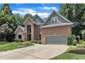 Beautiful brick home with a manicured lawn and mature trees offering great curb appeal at 5309 Overtop Ln, Raleigh, NC 27613