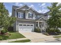 Beautiful two-story home featuring a two-car garage, manicured lawn, and traditional architectural details at 554 Beacon Ridge Blvd, Chapel Hill, NC 27516