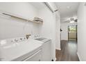 Convenient laundry area with washer, dryer, and storage shelving, conveniently located at 600 Audubon Lake Dr # 4B11, Durham, NC 27713