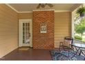 Charming porch featuring a brick accent wall, and comfortable seating area at 601 E Franklin St, Raleigh, NC 27604