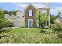 Charming two-story home with brick and siding, a well-manicured lawn, and mature trees at 601 Texanna Way, Holly Springs, NC 27540