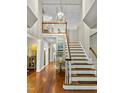 Elegant foyer featuring hardwood floors, grand staircase, and sophisticated decor at 603 Edburton Ct, Hillsborough, NC 27278