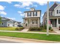 Attractive two-story home featuring a cozy front porch and manicured front lawn at 710 Vine Pkwy, Pittsboro, NC 27312
