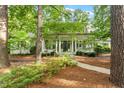 Charming home with a welcoming front porch, lush greenery, and mature trees creating a serene setting at 800 Lakestone Dr, Raleigh, NC 27609