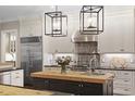 Well-appointed kitchen with stainless steel appliances, butcher block island, and stylish pendant lighting fixtures at 800 Lakestone Dr, Raleigh, NC 27609