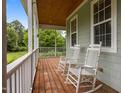 Inviting porch with wooden floors and rocking chairs, perfect for relaxing outdoors at 100 Virginia Lee Ln, Efland, NC 27243