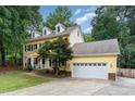 Charming yellow two-story home with black shutters, dormers, and manicured lawn at 1001 Kingsway Dr, Apex, NC 27502