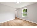 An empty bedroom with hardwood floors, natural lighting, and neutral colored walls at 1006 S Second Ave Ave, Siler City, NC 27344