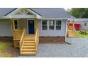 Gray home with a welcoming new wooden porch and stairs, showcasing quality craftsmanship at 1006 S Second Ave Ave, Siler City, NC 27344