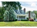 Picturesque home with a cozy front porch, complemented by a lush green lawn and mature trees at 101 Stefi Ct, Garner, NC 27529