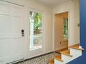 Bright entryway with decorative tile floors and a view of the outdoor front porch at 10101 Daviton Ct, Raleigh, NC 27615