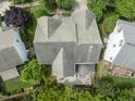 Overhead view of a home's roofline and backyard, including an outdoor dining and lounge area at 10859 Bedfordtown Dr, Raleigh, NC 27614