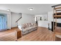 Bright living room boasts natural light, hardwood floors, and a cozy fireplace at 110 Knightwood Dr, Durham, NC 27703
