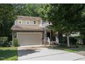 Charming two-story home with a stone facade, attached garage, and well-manicured front yard at 1304 Barnford Mill Rd, Wake Forest, NC 27587