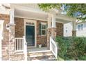 Charming front porch with stone accents and manicured landscaping offering inviting curb appeal at 1304 Barnford Mill Rd, Wake Forest, NC 27587