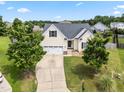 Aerial of a beautiful single-Gathering home with a well-kept lawn and an inviting driveway at 1400 Manley Ct, Fuquay Varina, NC 27526