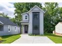 Charming two-story home featuring modern architectural design, concrete driveway, and well-maintained lawn at 1410 Joe Louis Ave, Raleigh, NC 27610