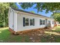 Vinyl-sided home featuring dark shutters, well-maintained siding, and a neatly kept lawn and walkways at 1442 Morningside Dr, Burlington, NC 27217
