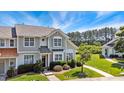 Inviting townhome exterior with lush landscaping, complemented by a sunny sky at 15 Canary Ct, Durham, NC 27713