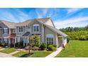 Well-maintained townhome featuring a beautifully landscaped front yard and inviting curb appeal at 15 Canary Ct, Durham, NC 27713