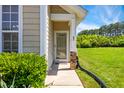 Cozy front porch with brick accents, leading to a welcoming front door and landscaped surroundings at 15 Canary Ct, Durham, NC 27713