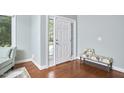 Bright foyer with hardwood floors, natural light, and stylish bench at 1601 Bellenden Dr, Durham, NC 27713