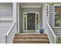Inviting front entrance with brick steps, elegant door, and address numbers at 1601 Bellenden Dr, Durham, NC 27713