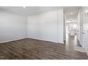 Bright and spacious living room featuring modern flooring, neutral paint, and a view into the kitchen at 167 Young Farm Dr, Lillington, NC 27546