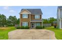 Charming two-story home with a well-manicured lawn and concrete driveway at 19 Kimberly Ct, Lillington, NC 27546