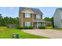 Charming two-story home with a well-manicured lawn and concrete driveway at 19 Kimberly Ct, Lillington, NC 27546