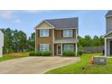 Charming two-story home with a well-manicured lawn and concrete driveway at 19 Kimberly Ct, Lillington, NC 27546