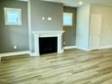 Living room featuring a fireplace and light colored wood flooring at 1915 Plott Balsam Dr, Wendell, NC 27591