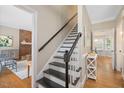Elegant staircase with black and white risers and hardwood floors at 2008 Corberrie Ln, Raleigh, NC 27613