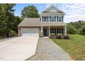 Charming two-story home featuring a brick and siding facade, attached garage, and a well-maintained front yard at 2021 W Front St, Burlington, NC 27215