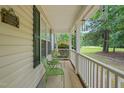 Inviting front porch with green metal chairs, ideal for relaxing outdoors at 2116 Sterling Creek Ln, Franklinton, NC 27525