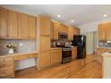 Kitchen with hardwood floors, stainless appliances and ample cabinet storage at 2311 Woodwyck Way, Raleigh, NC 27604