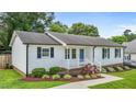 Charming white house with well-manicured landscaping and a walkway leading to the front entrance at 2324 Hoskins Rd, Burlington, NC 27215