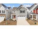 Beautiful two-story home with neutral siding, a two-car garage, and a welcoming, bright red front door at 2346 Mckenzie Ridge Ln, Apex, NC 27502
