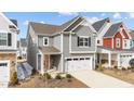 Charming two-story home with neutral siding, attached two-car garage, and an inviting red front door at 2346 Mckenzie Ridge Ln, Apex, NC 27502
