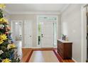 Bright foyer with hardwood floors, complemented by natural light and traditional accents at 2425 Lemuel Dr, Raleigh, NC 27615