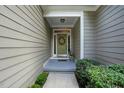Close up of a lovely front door with a wreath, covered entryway, and landscaped surroundings at 2425 Lemuel Dr, Raleigh, NC 27615